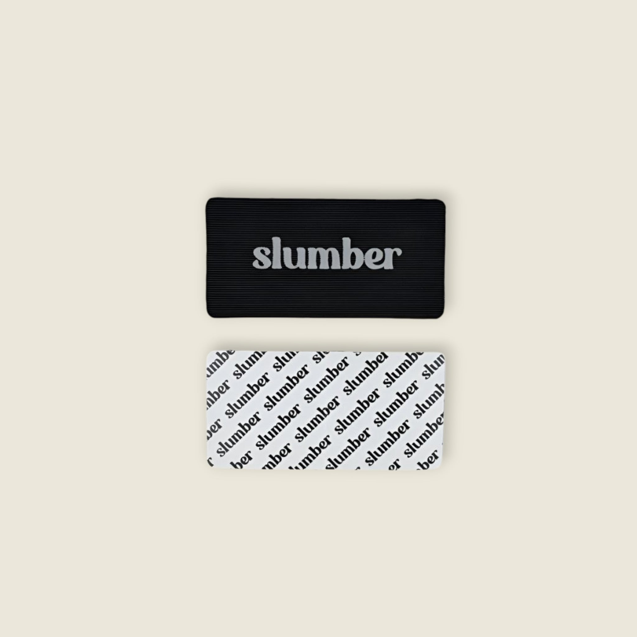 Close-up of Slumber mouth tape in black and white designs, showcasing branding and material details.
